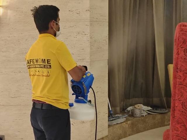 Safe Home Pestochem technician treating furnishings inside a commercial building