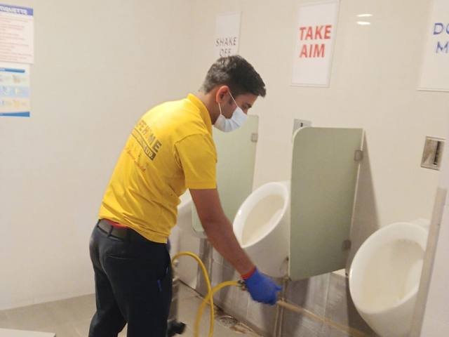 Safe Home Pestochem technician treating and disinfecting a washroom in a healthcare facility